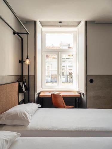 a bedroom with a bed and a window at Inspira Santos Boutique Hotel in Lisbon