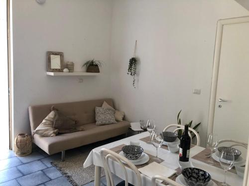 a living room with a table and a couch at Casa Laura a due passi dal mare in Rimini
