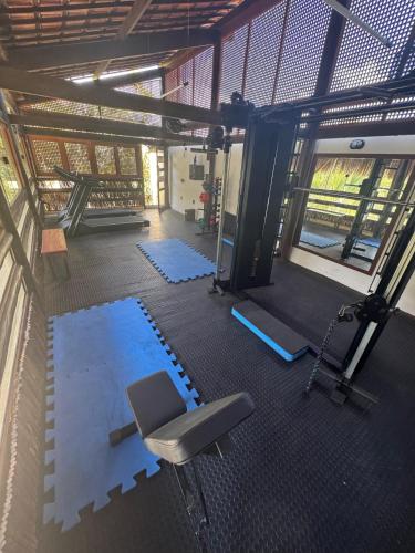 an overhead view of a gym with a chair and weights at Solar de Pipa Prime - Frente piscina in Pipa