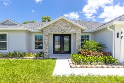 a house with a green lawn at Coosa Dr in Port Saint Lucie