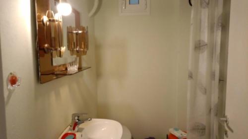 a bathroom with a sink and a toilet and a mirror at villa by the sea in Káto Alepokhórion