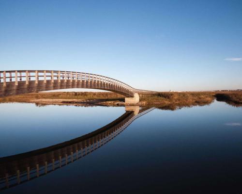 a bridge over a body of water at Ricardo beach house in Esmoriz