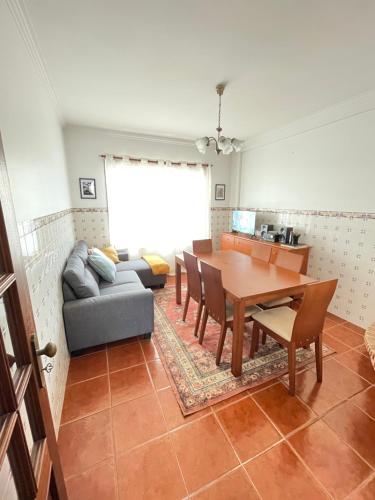 a living room with a table and a couch at Ricardo beach house in Esmoriz