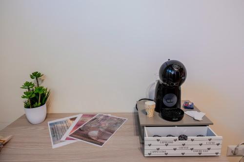 a table with a hair dryer and books on it at B&B Etesia in Vibo Valentia