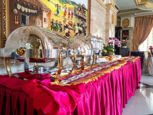 een tafel in een kamer met een roze tafelkleed bij Hotel Arca lui Noe in Sinaia