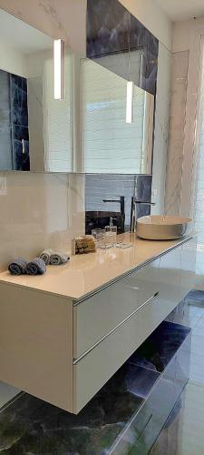 a kitchen with a counter top with a mirror at Villa Flora Lake Como - Villa con piscina in Asso