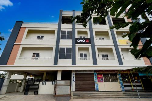 an apartment building with the one st sign on it at Hotel O SR Grand in Bībīnagar