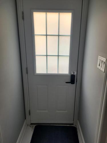 a white door with a window in a room at individual home in Brampton