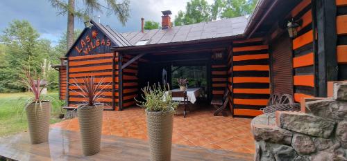 a house with a patio with potted plants in front of it at Rancho Wilga in Wilga
