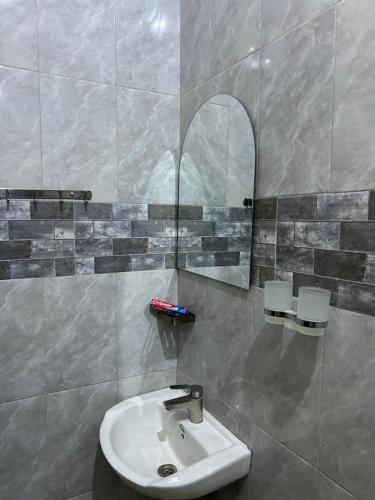 a bathroom with a sink and a mirror at Comfort home in Msaranga