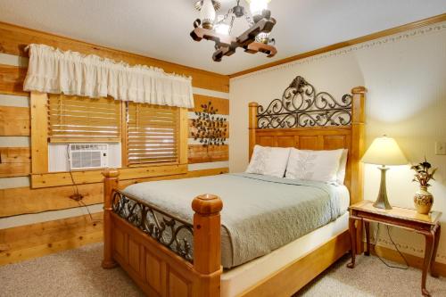 a bedroom with a wooden bed and a window at Golfers Getaway Hephzibah Home with Pool Access in Hephzibah