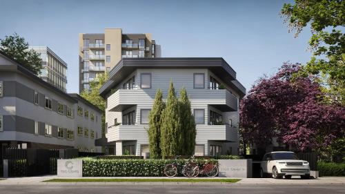 a white building with bikes parked in front of it at The Como Hotel in Vancouver