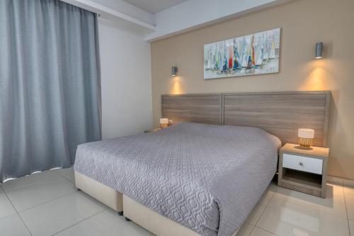 a bedroom with a large bed and two night stands at Bellini Hotel in Ayia Napa