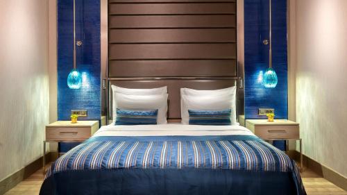 a bedroom with a large bed and two night stands at Crowne Plaza Florya Istanbul by IHG in Istanbul