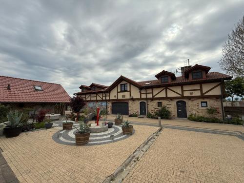 a large building with a courtyard with potted plants at Agroturystka Jaśkowo 