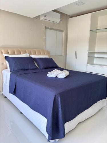 a bedroom with a blue bed with two towels on it at Pousada Sousa Residencial Qrt1 in Sousa