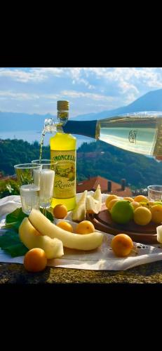 a table with a bottle of oil and some fruit at Villa Silvana in Perledo