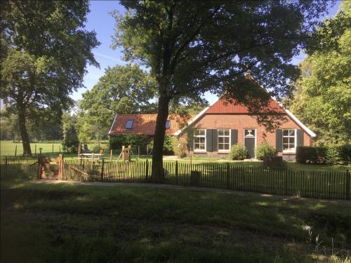 a house with a fence in front of it at B&B 't Varkenshuus in Aalten