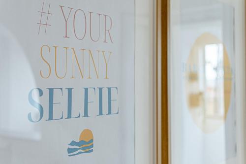 a window with a sign that reads if your own seilty at Barceloneta Experience Suite & Rooms in Alghero