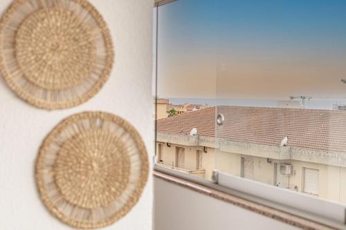 a view of a building from a window at Barceloneta Experience Suite & Rooms in Alghero