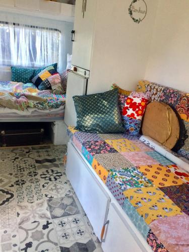 a room with two beds and a couch at Glamping du loup garou in Bléré