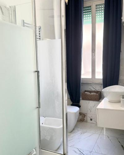 a bathroom with a shower and a toilet and a sink at Volupta' s house Trastevere Station in Rome