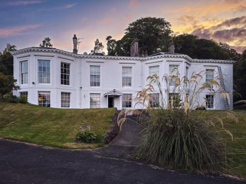 a large white house with a lawn in front of it at 2 Bed Flat - Sleeps 4 - Pets - Parking - Wifi in Rothesay