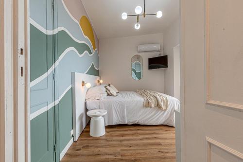 a small bedroom with a bed and a toilet at Barceloneta Experience Suite & Rooms in Alghero