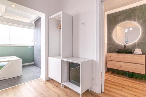 a bathroom with a sink and a mirror at Barceloneta Experience Suite & Rooms in Alghero