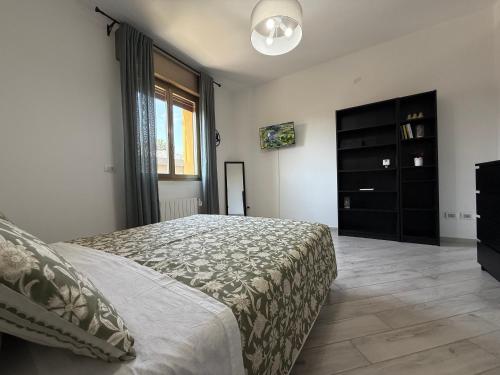 a bedroom with a bed and a black dresser at Orlandi Elegant Apartment in Bologna