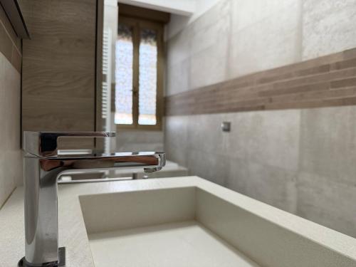 a bathroom with a sink and a mirror at Orlandi Elegant Apartment in Bologna