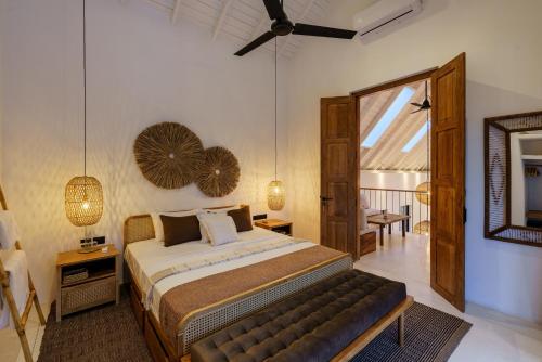 a bedroom with a large bed and a mirror at Terrene Villa in Weligama