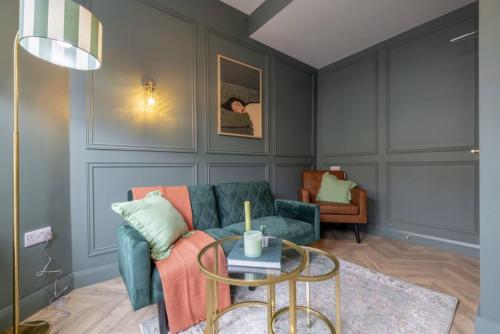 a living room with a couch and a table at Beautiful townhouse in Carrickfergus
