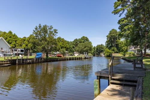 a dock with a bench next to a river at 3054 - Latitude Adjustment in Southern Shores