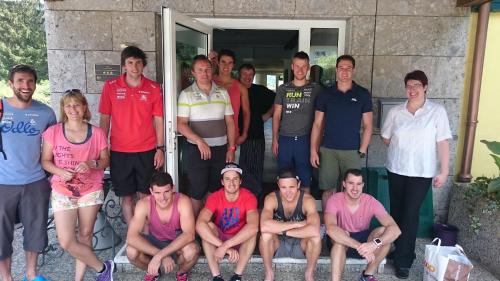 a group of people posing for a picture in front of a door at Hotel-Restaurant Bellevue in Ruhpolding