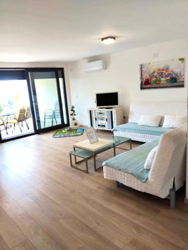 a living room with a couch and a tv at Apartment Crikvenica Trg Duga in Crikvenica
