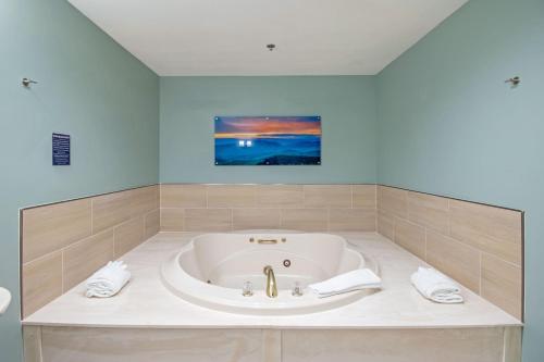 a large bath tub in a bathroom with a sink at Massanutten's Woodstone Meadows by TripForth in McGaheysville