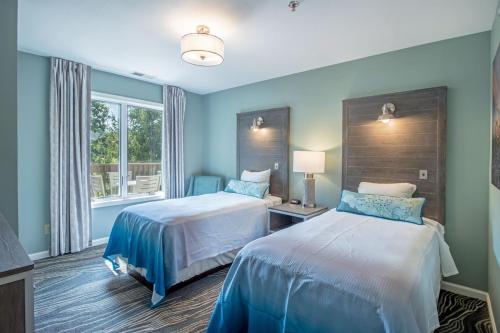 a hotel room with two beds and a window at Massanutten's Woodstone Meadows by TripForth in McGaheysville