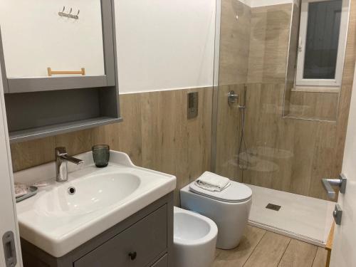 a bathroom with a sink and a toilet and a shower at Bella Napoli Guesthouse Trattoria Pizzeria in La Spezia