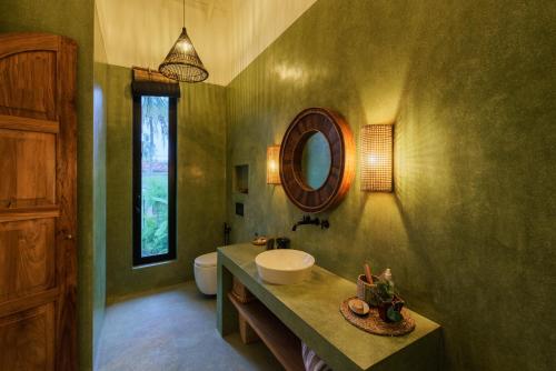 a bathroom with a sink and a mirror at Terrene Villa in Weligama