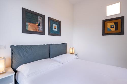 a bedroom with a bed and three pictures on the wall at Casa Vacanze Panorama in Brunate