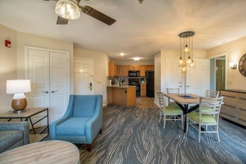 a living room with a table and a blue chair at Massanutten's Woodstone Meadows by TripForth in McGaheysville