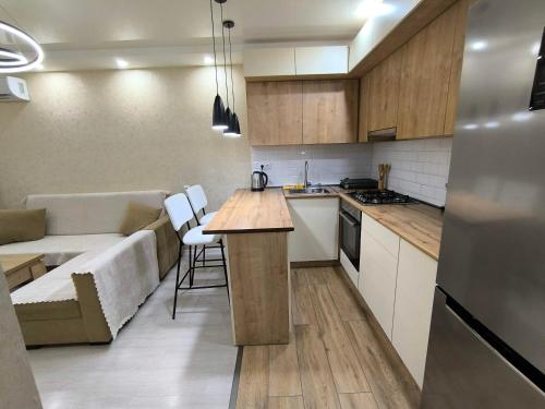 a kitchen and living room with a couch and a table at mary's house in Tbilisi City