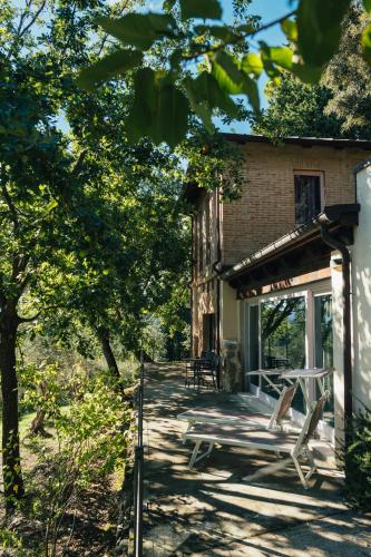 a porch of a house with chairs on it at Villa Liverzano in Brisighella