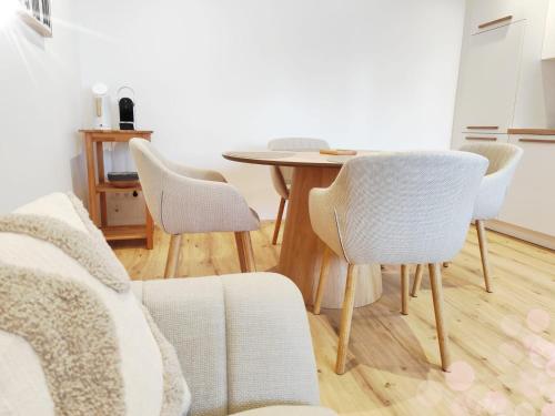 a table and chairs in a living room with a table at Living OH43 in Illmitz