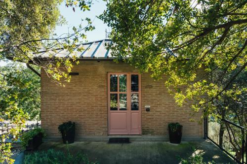 a brick house with a pink door at Villa Liverzano in Brisighella