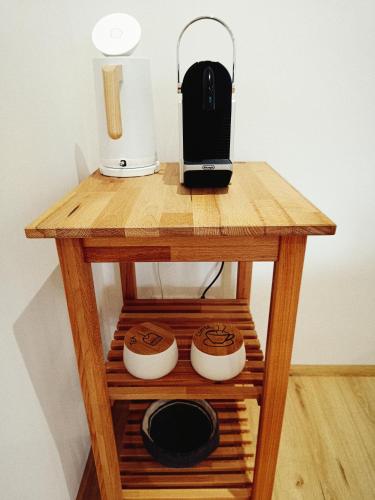 a small wooden table with a coffee maker on it at Living OH43 in Illmitz