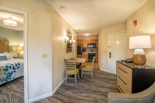 a hotel room with a bed and a dining room at Massanutten's Woodstone Meadows by TripForth in McGaheysville