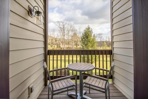a patio with a table and two chairs on a balcony at Massanutten's Woodstone Meadows by TripForth in McGaheysville
