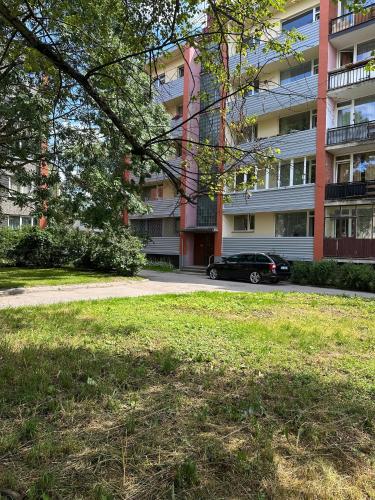 a car parked in front of a building at Jelgava Center Apartment with a View and Balcony in Jelgava